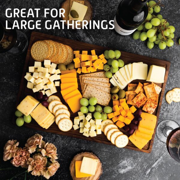 A wooden tray with cheese and crackers on it