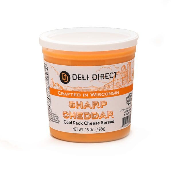 A container of sharp cheddar cheese spread.
