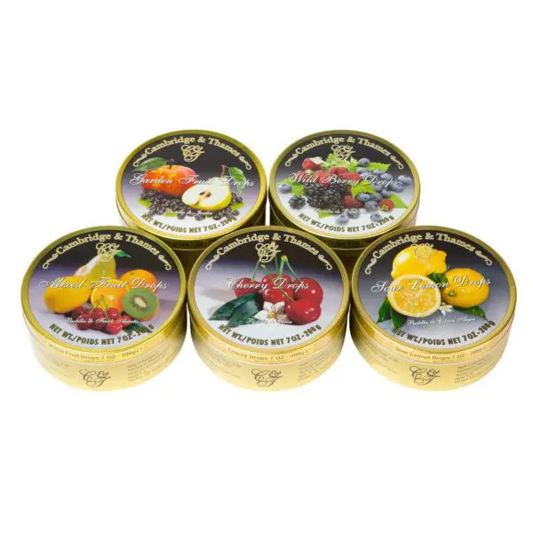 A group of five tins with different types of fruit on them.