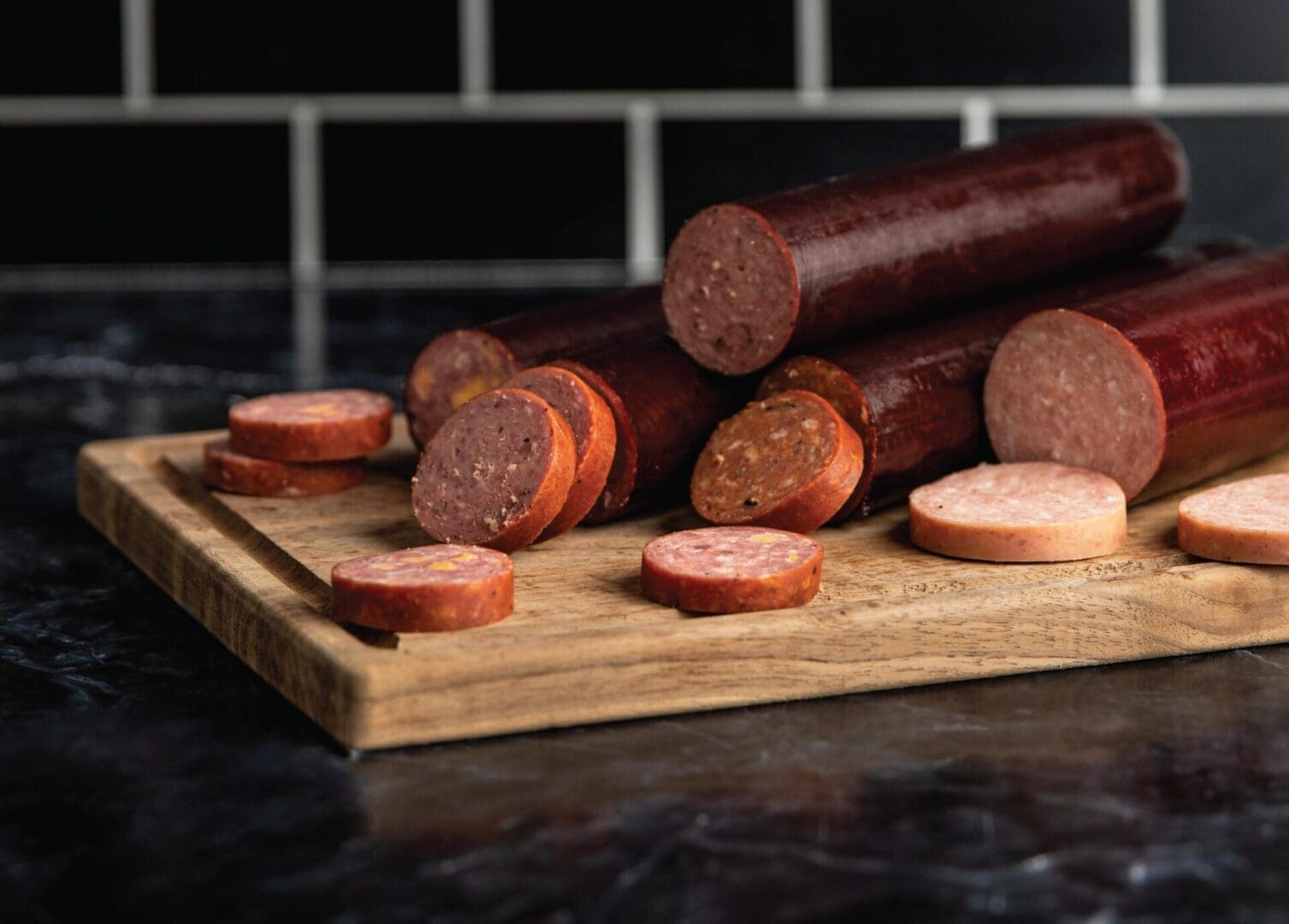 Specialty sausages displayed on a rustic wooden cutting board.